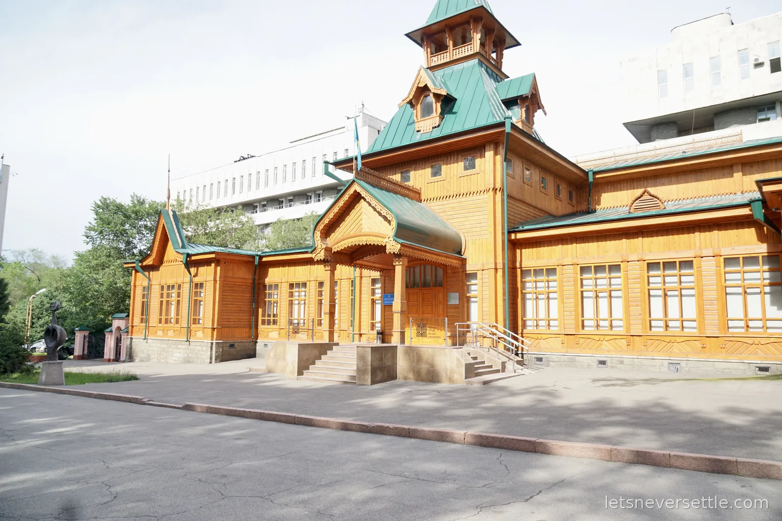 The Museum of Kazakh Folk Musical Instruments in Almaty, an ornate wooden building with green metal roofs and a small tower