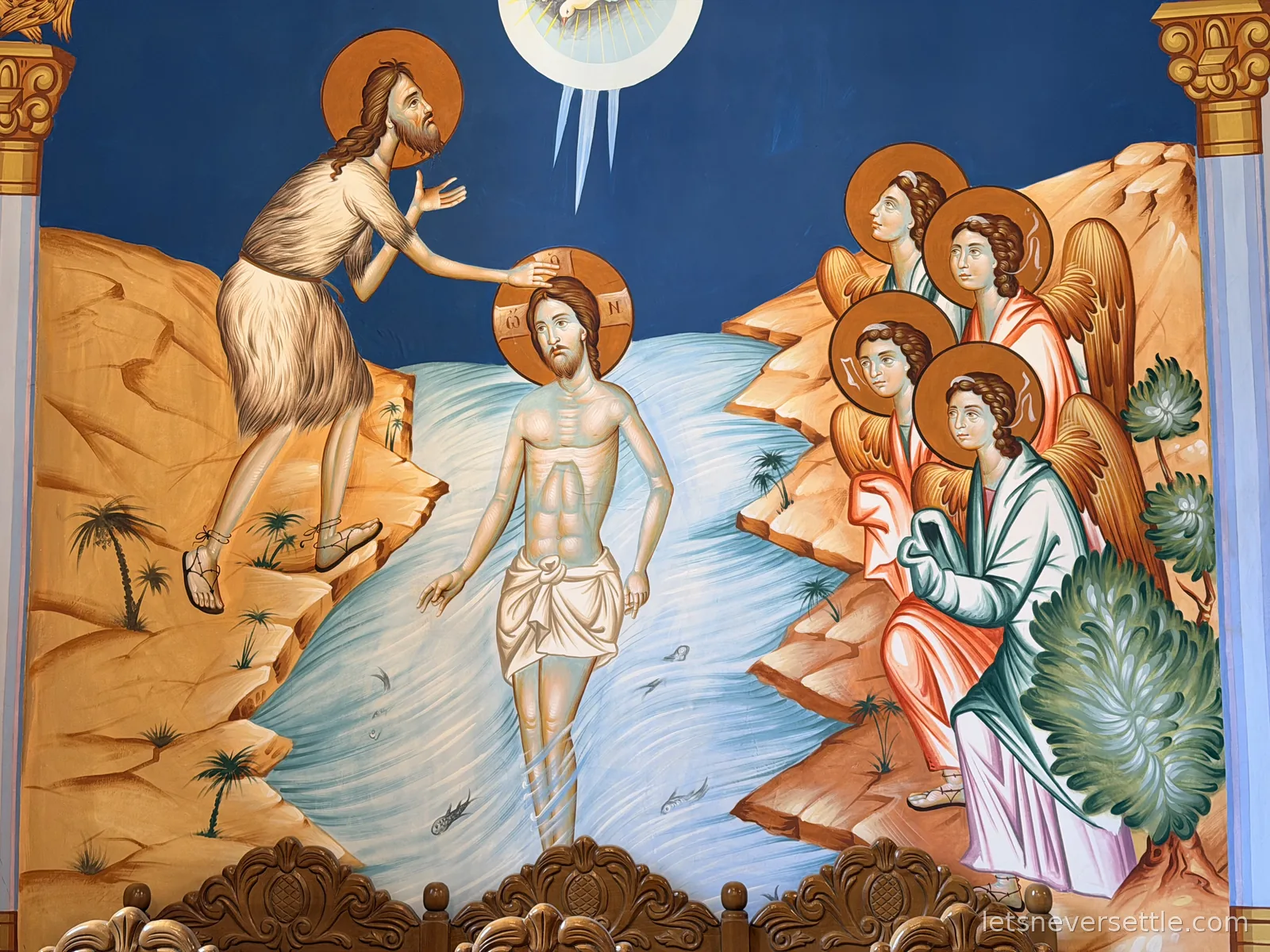A vivid fresco of the baptism of Jesus in the River Jordan, with John the Baptist on the bank and four angels watching