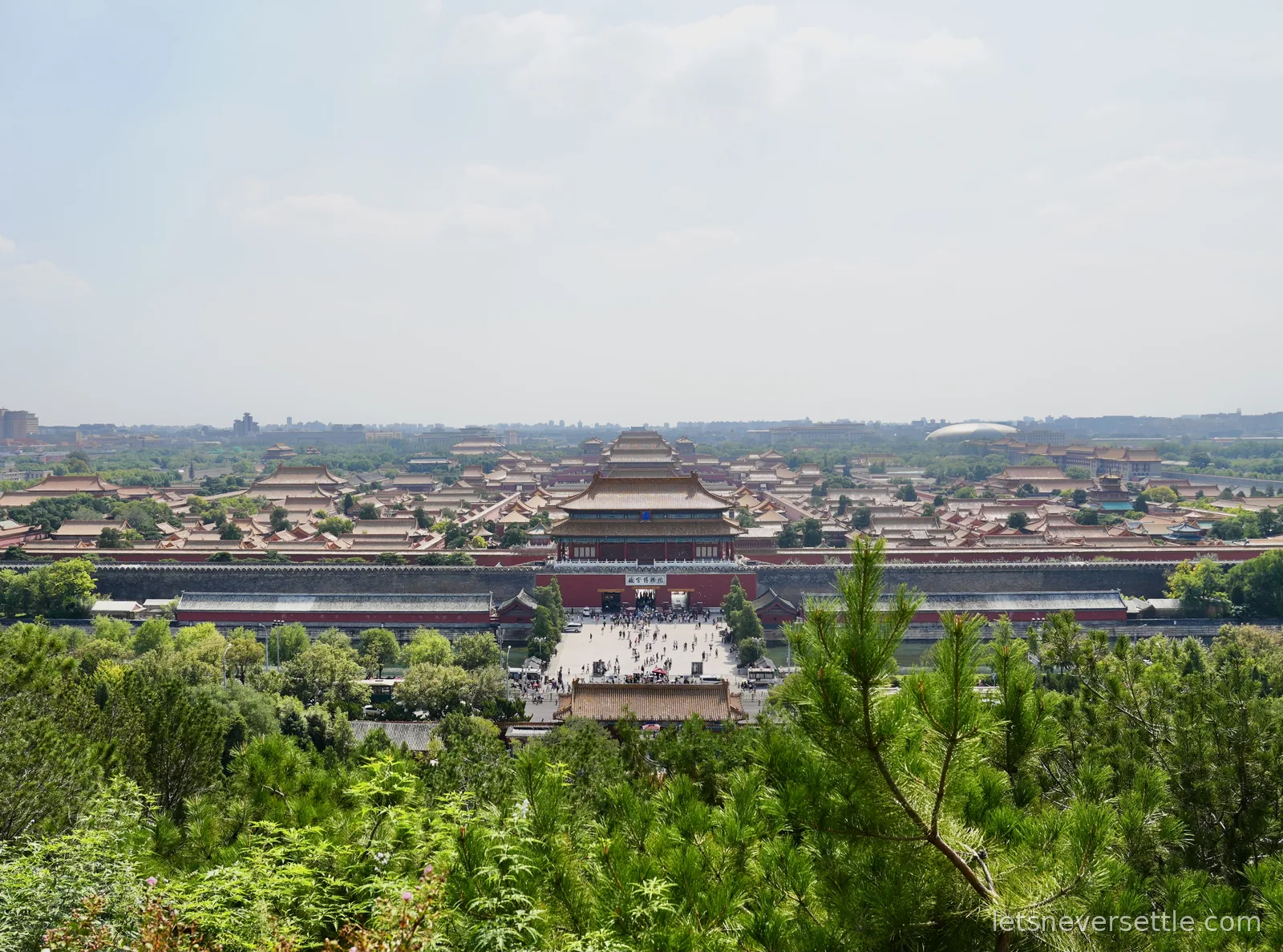 Panorama of the Forbidden City rooftops seen from Jingshan Park, golden halls stretching to the Beijing skyline