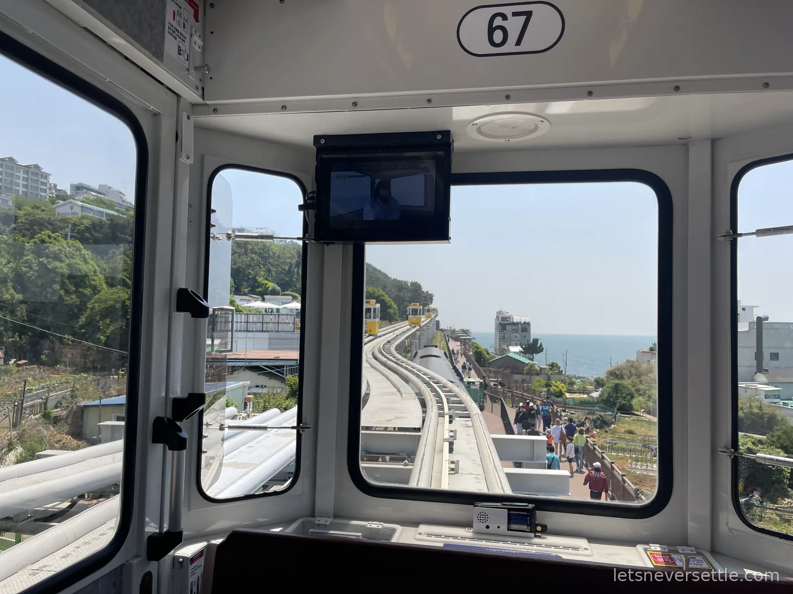 View from inside Sky Capsule car 67 on the elevated Haeundae Blueline track running along the coast