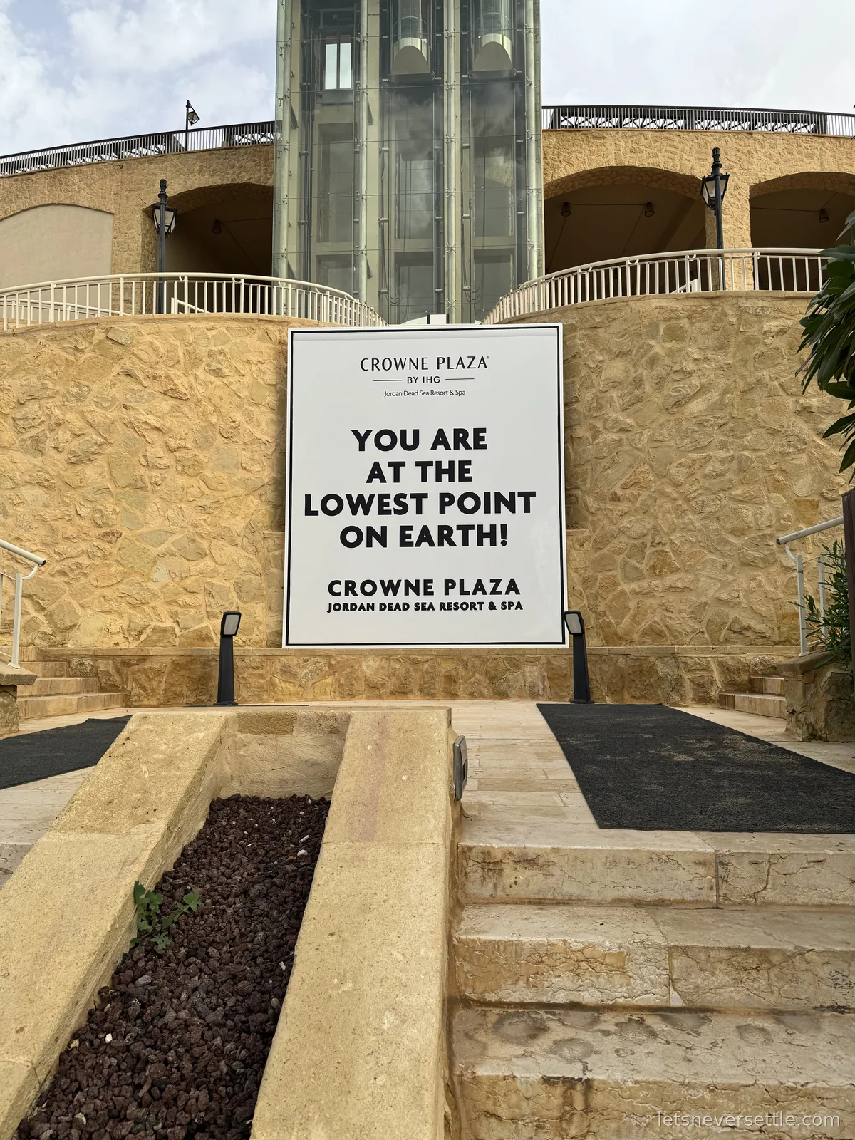 A large sign at the Crowne Plaza Jordan Dead Sea Resort reading You are at the lowest point on Earth