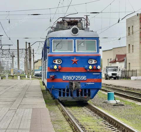A blue Soviet-built VL80 electric locomotive standing under the overhead wires