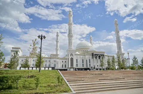 A white domed mosque in Astana with slender minarets under a big open sky