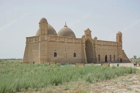 The brick mass of the Khoja Ahmed Yasawi mausoleum at Turkistan, seen across the grass