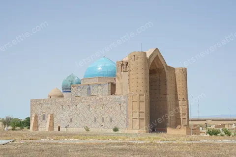 The Yasawi mausoleum from the side, turquoise dome above the unfinished brick front