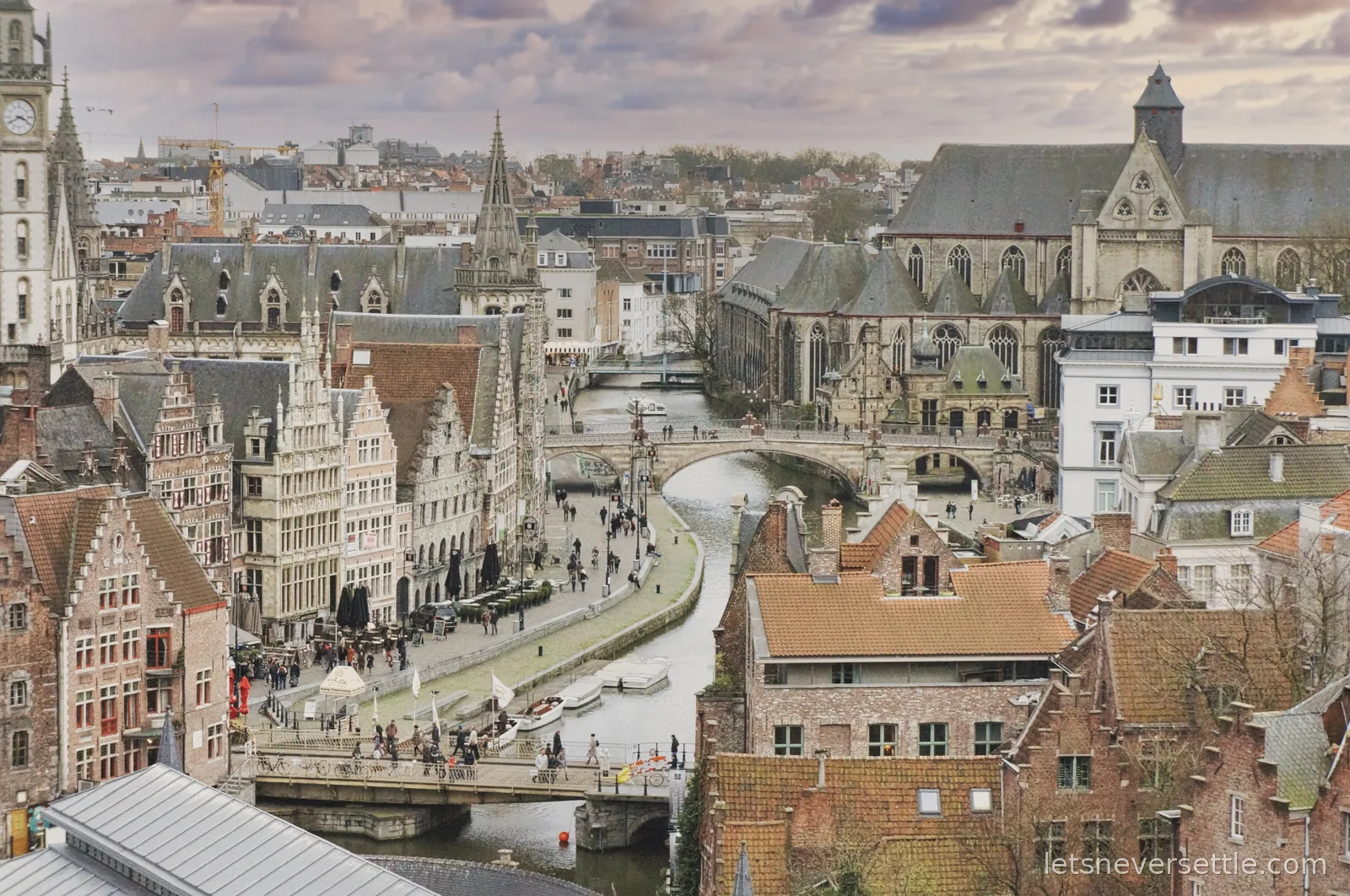 Aerial view from the Ghent belfry over the Graslei guild houses, St Michael's Bridge and St Michael's Church under an evening sky