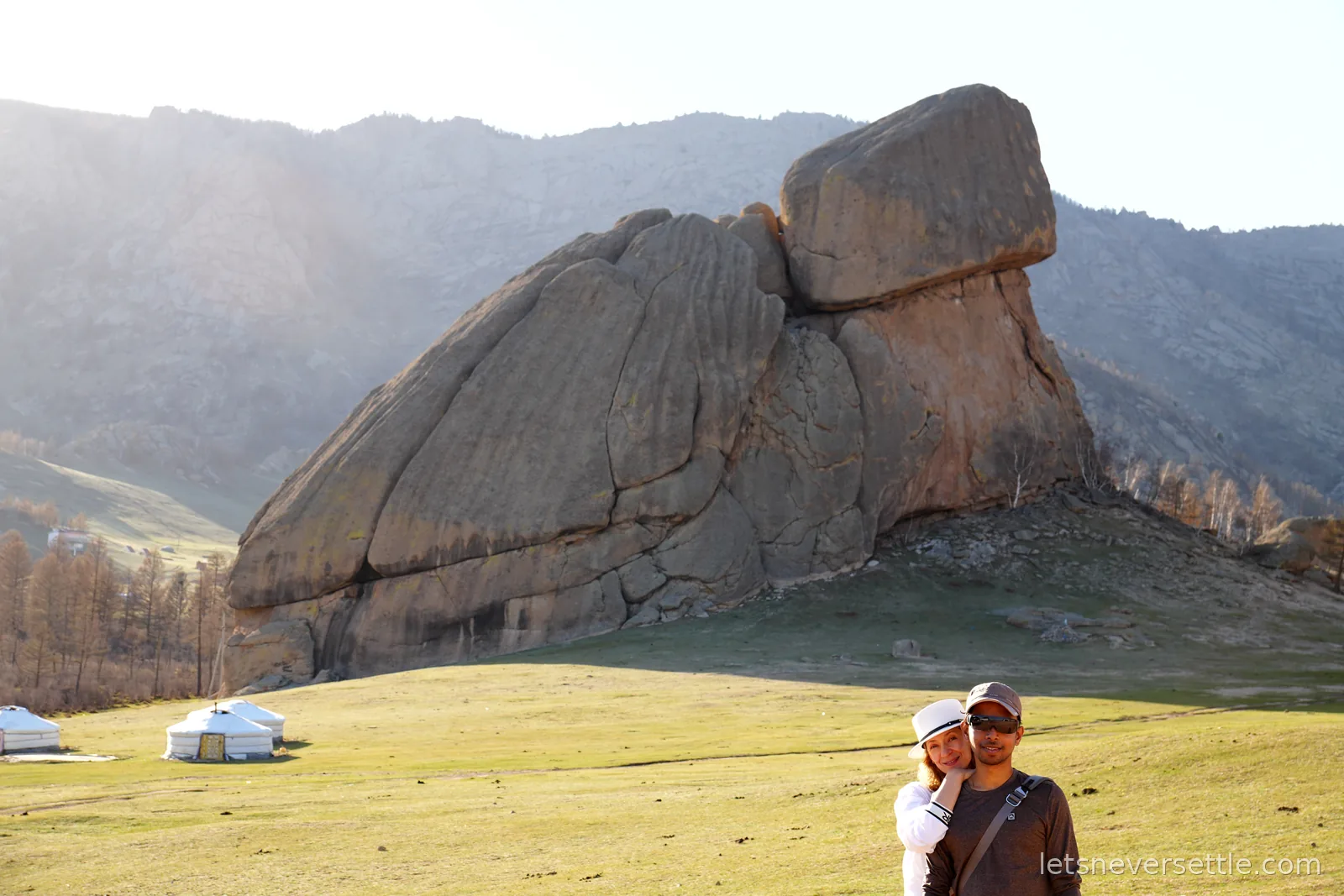 Inga and Dileep in front of Turtle Rock in Gorkhi-Terelj National Park, a huge granite formation shaped like a turtle with white gers on the meadow below