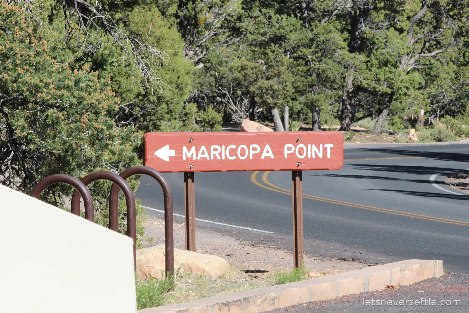 Maricopa Point sign with the Grand Canyon dropping away behind it