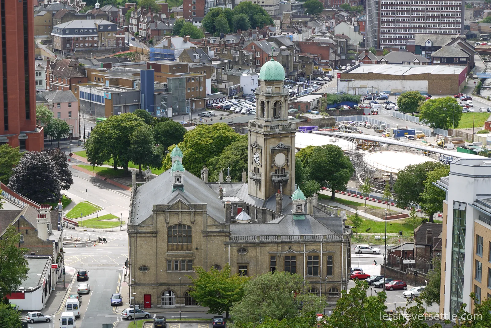 Aerial view over the rooftops of Chatham in Kent from the Great Lines, the old town hall with its green copper dome and clock tower in the centre, car parks and building works around it