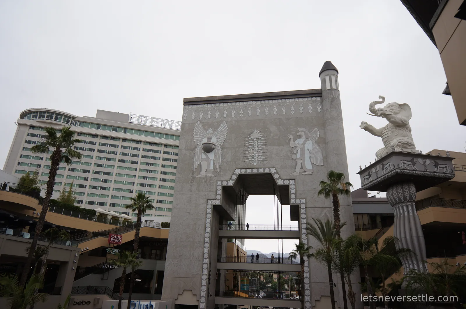 Babylon-style archway and white elephant statue of the Hollywood and Highland courtyard, the Loews hotel tower behind