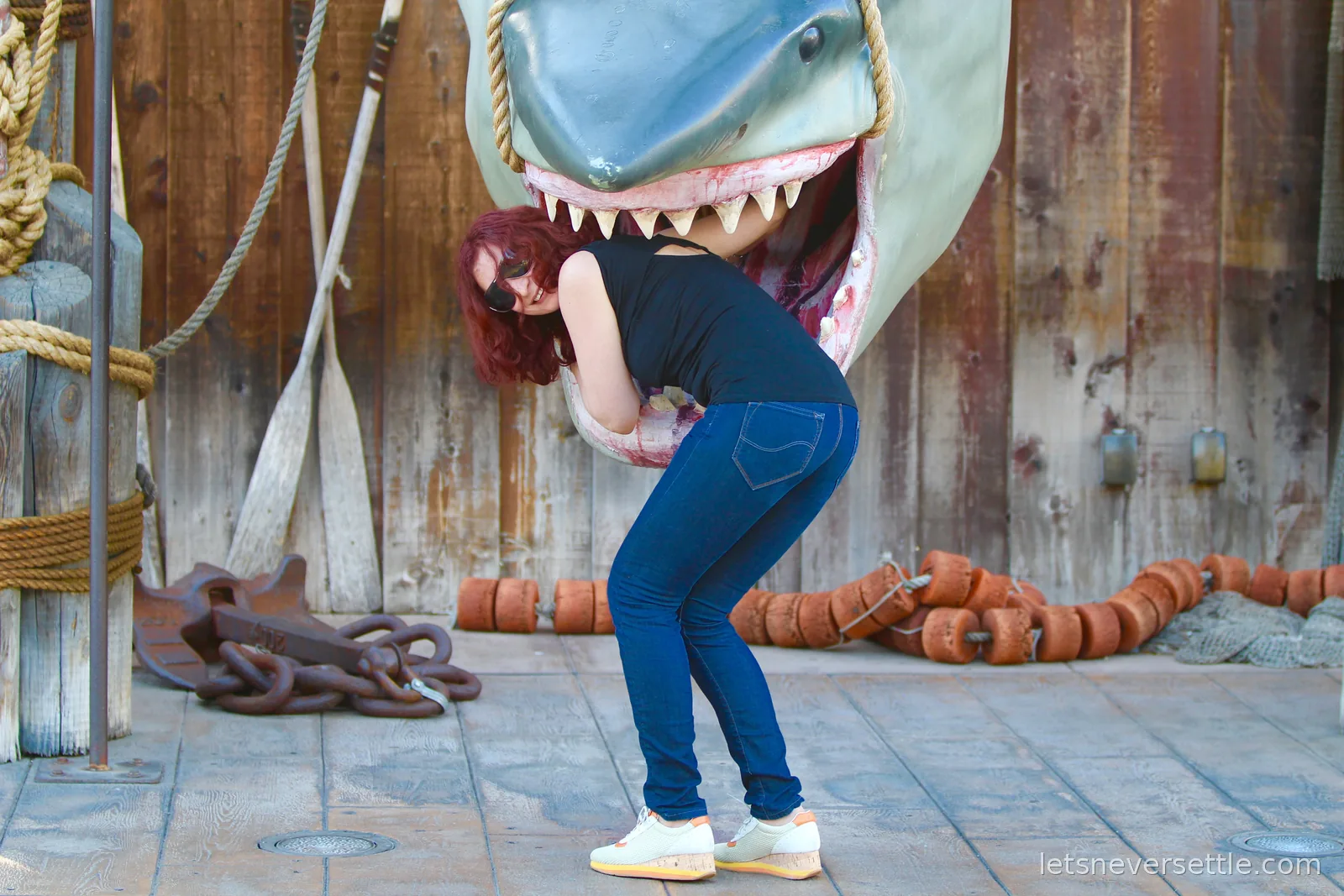 Inga standing inside the open jaws of the hanging Jaws shark prop at Universal Studios
