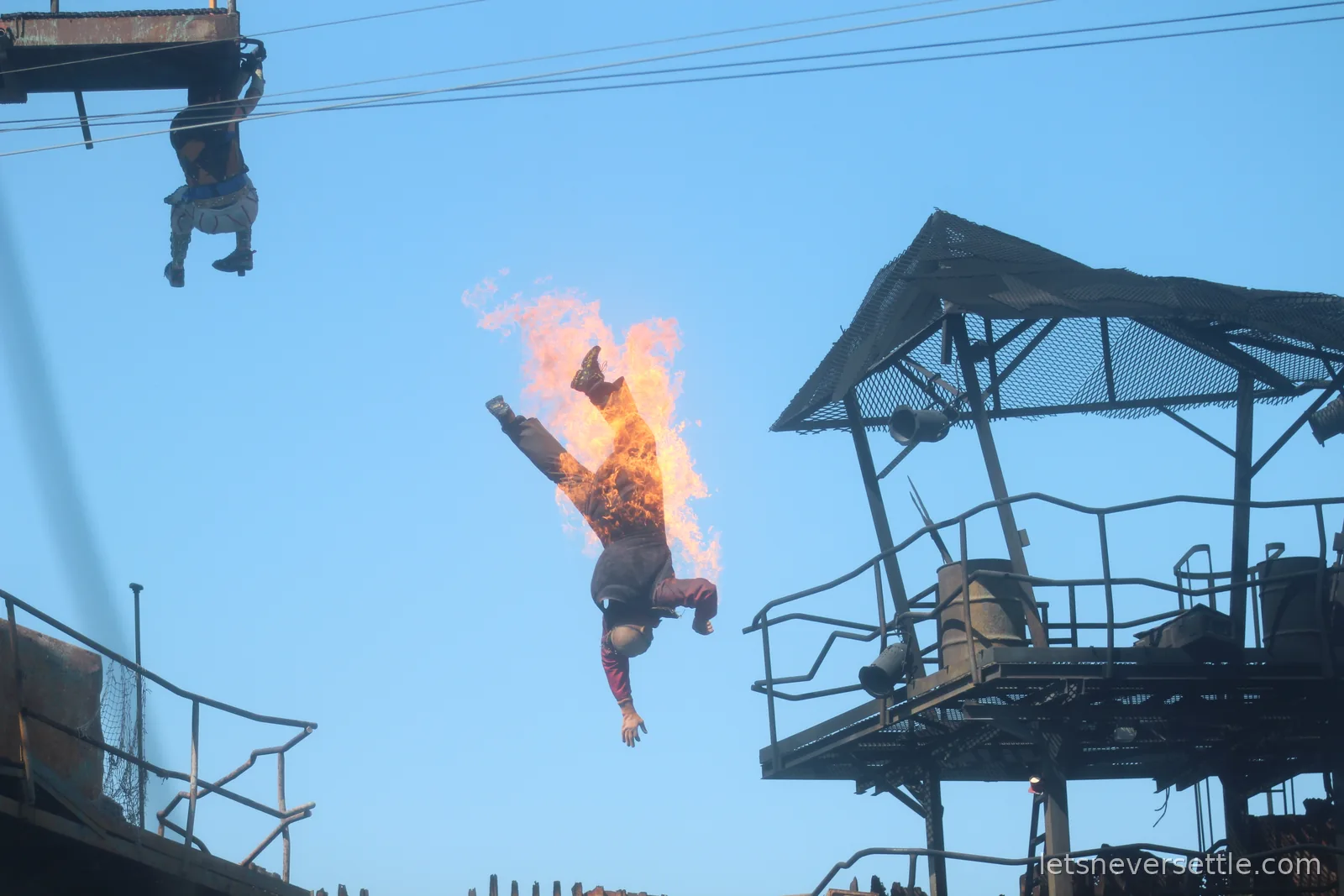 Stunt performer engulfed in flames mid-leap at the Waterworld show at Universal Studios