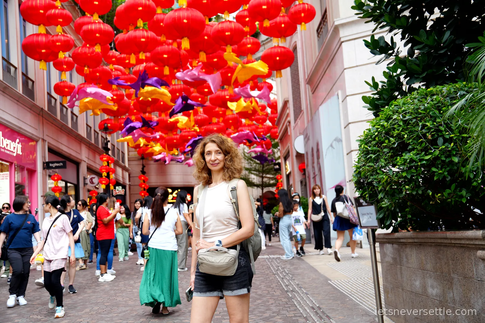 Inga beneath a canopy of hundreds of red lanterns and goldfish decorations strung over Lee Tung Avenue in Wan Chai