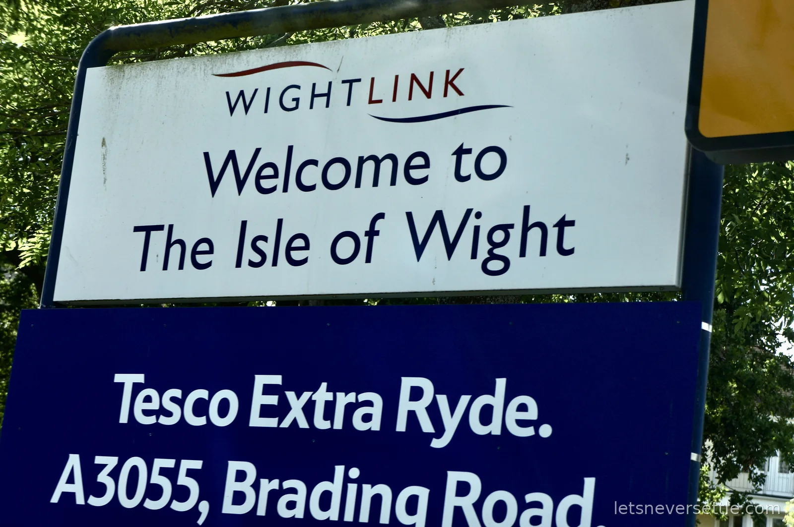 Wightlink sign reading Welcome to The Isle of Wight above a blue sign for Tesco Extra Ryde on the A3055 Brading Road