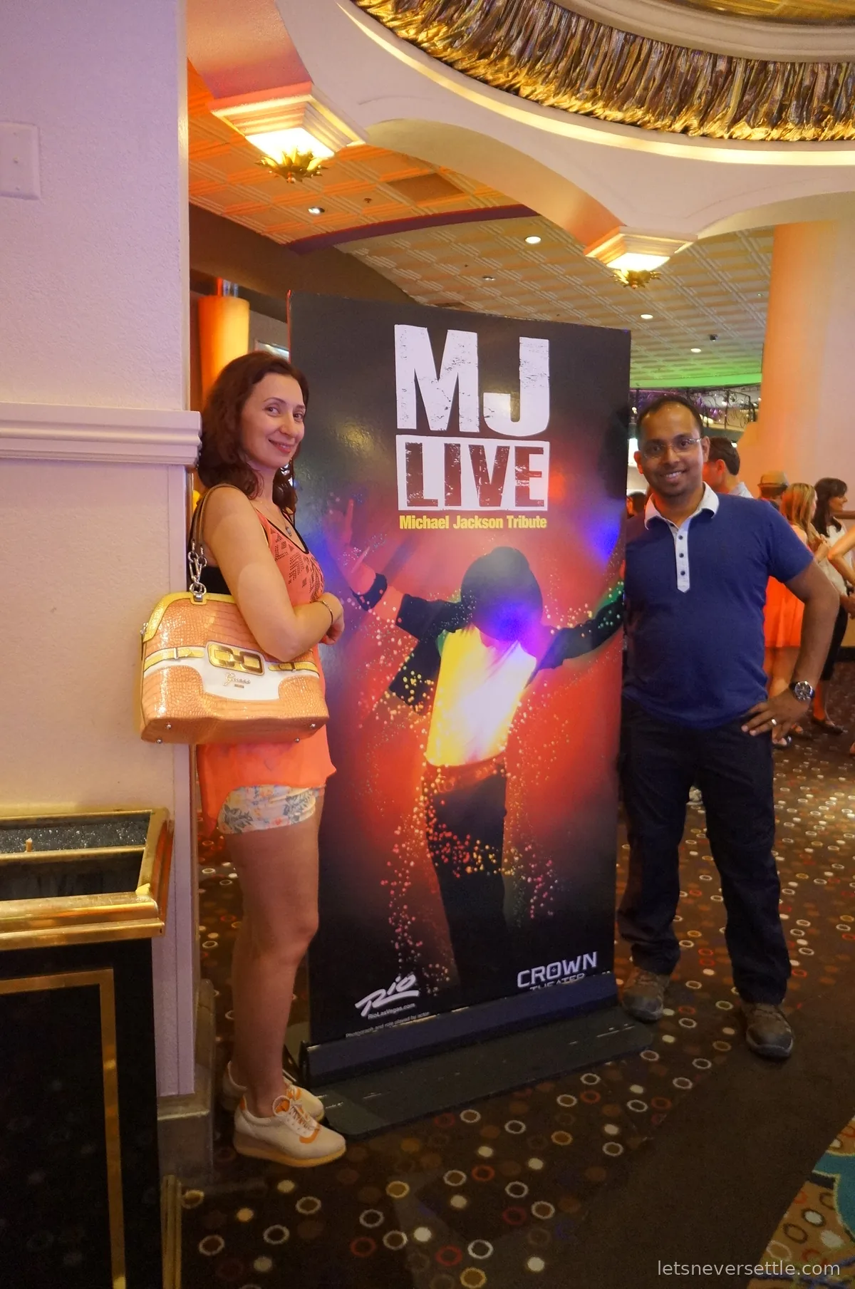 Inga and Dileep either side of an MJ Live Michael Jackson tribute poster at the Rio's Crown Theater