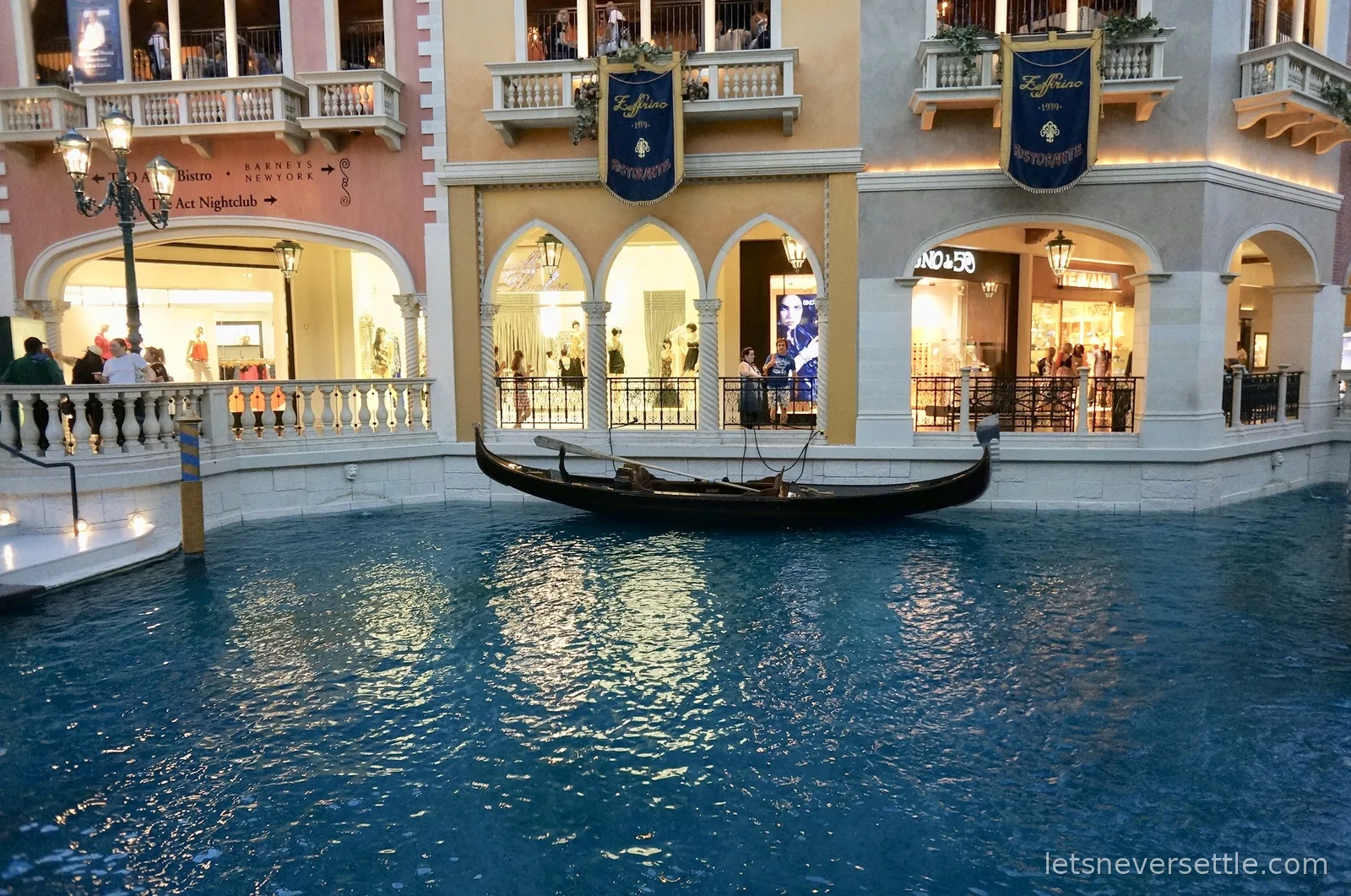 Gondola on the turquoise indoor canal of the Venetian under a painted sky