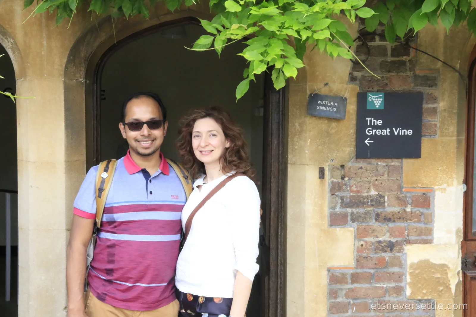 Inga and Dileep at the doorway of the glasshouse of the Great Vine at Hampton Court Palace