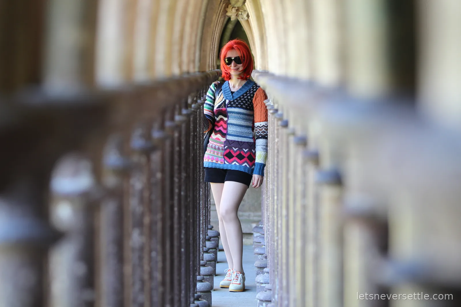 Inga standing between the double rows of slender columns in the abbey cloister