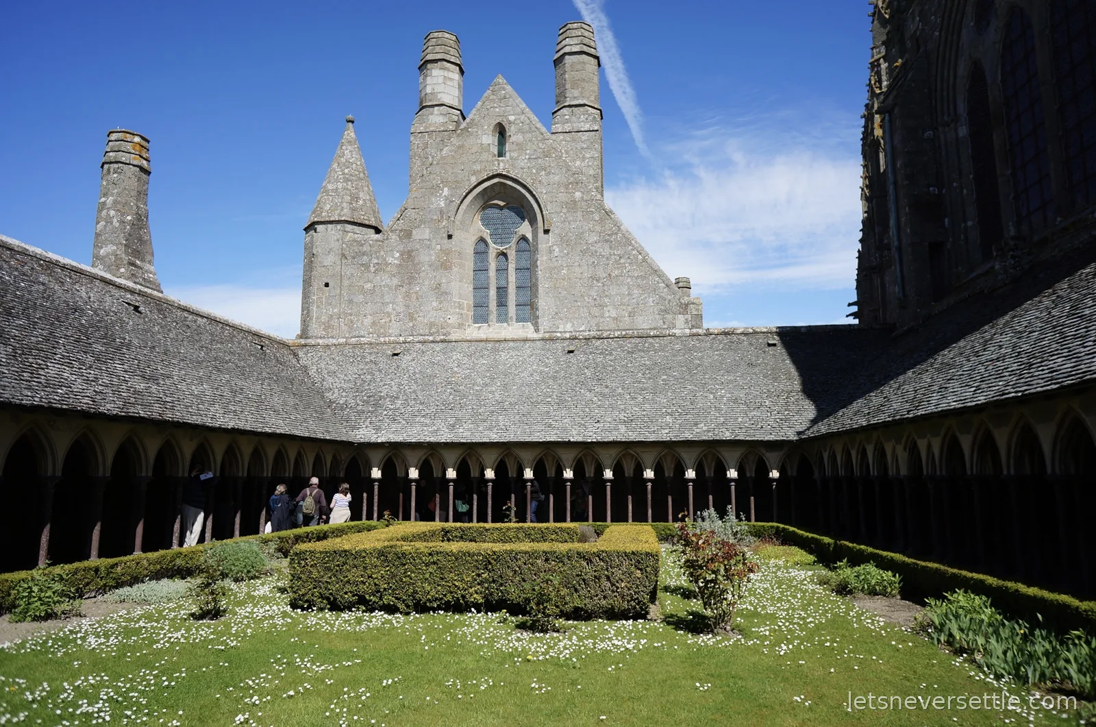 The cloister garden of Mont Saint-Michel abbey ringed by slender double columns
