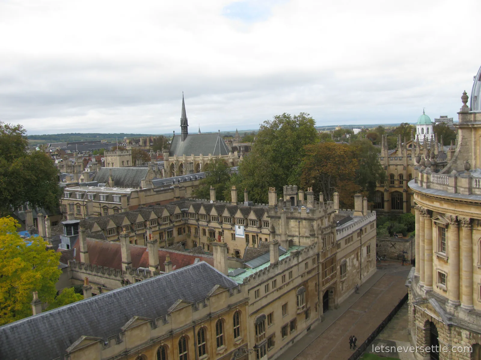 View from the University Church tower across Oxford college quads, rooftops and a distant chapel spire