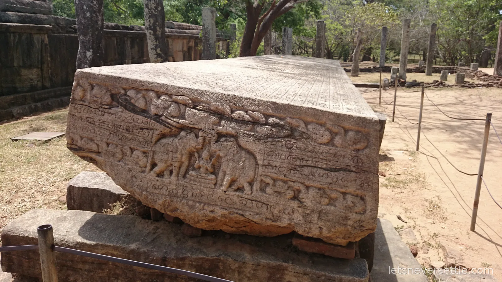 Gal Potha, a huge inscribed stone slab at Polonnaruwa carved with rows of ancient script and a frieze of figures and elephants