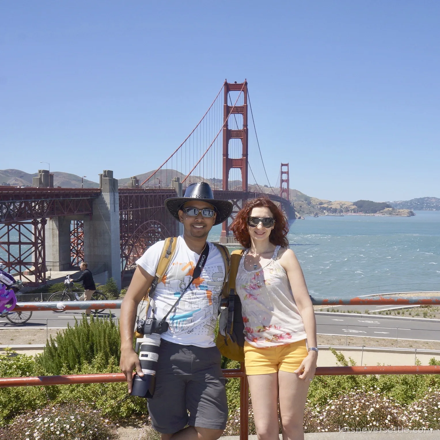 Inga and Dileep posing in front of the Golden Gate Bridge on a clear June day
