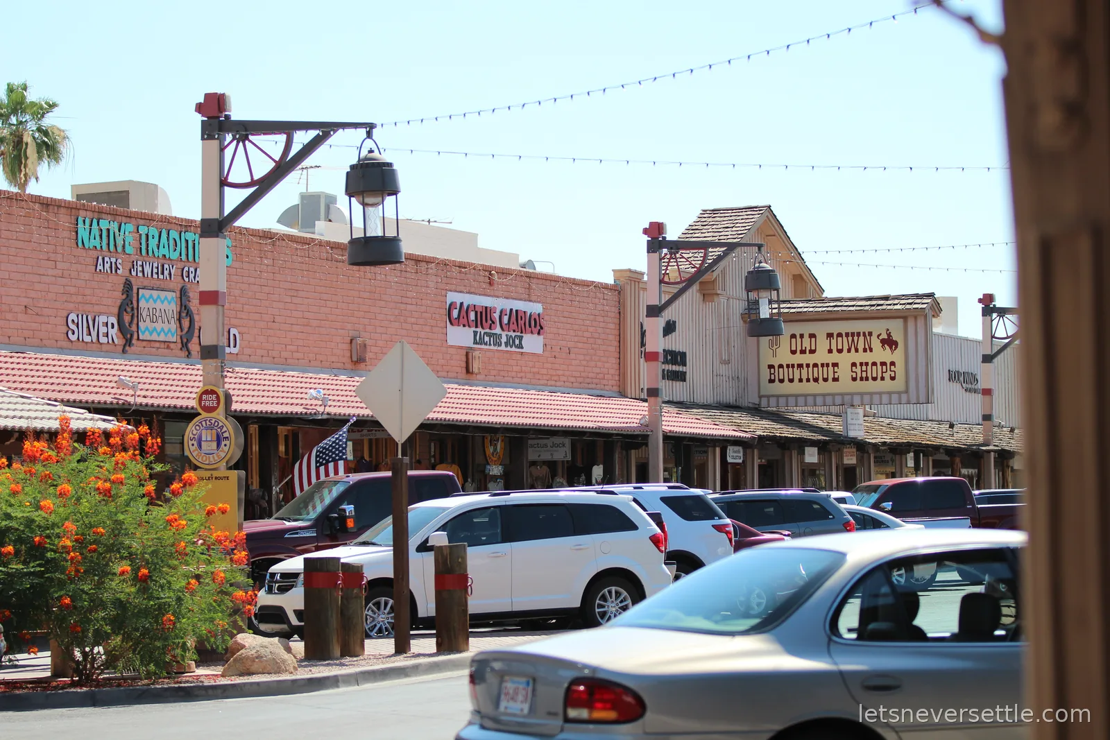 Old Town Scottsdale street with western-style storefronts, an Old Town Boutique Shops sign and a Scottsdale Trolley stop