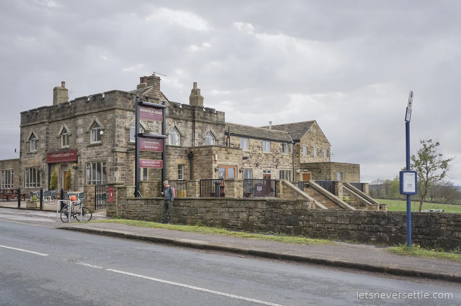 The stone-built Norfolk Arms Hotel with a castellated roofline at Ringinglow on the moor edge above Sheffield, under a grey sky
