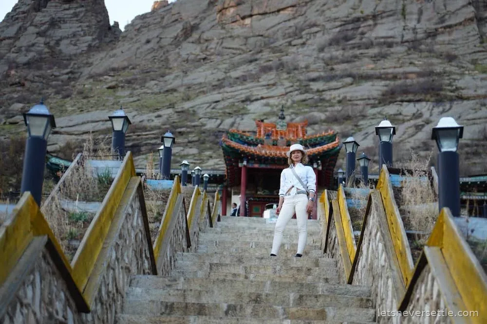 A long painted staircase climbing the rocky hillside to the Aryabal meditation temple in Gorkhi-Terelj, Mongolia