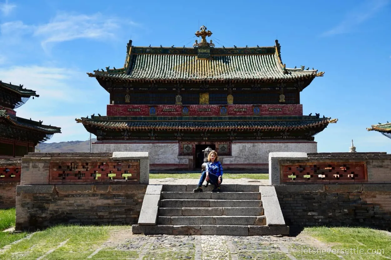 A temple building at Erdene Zuu monastery in Mongolia with a tiered roof and painted eaves under a clear sky