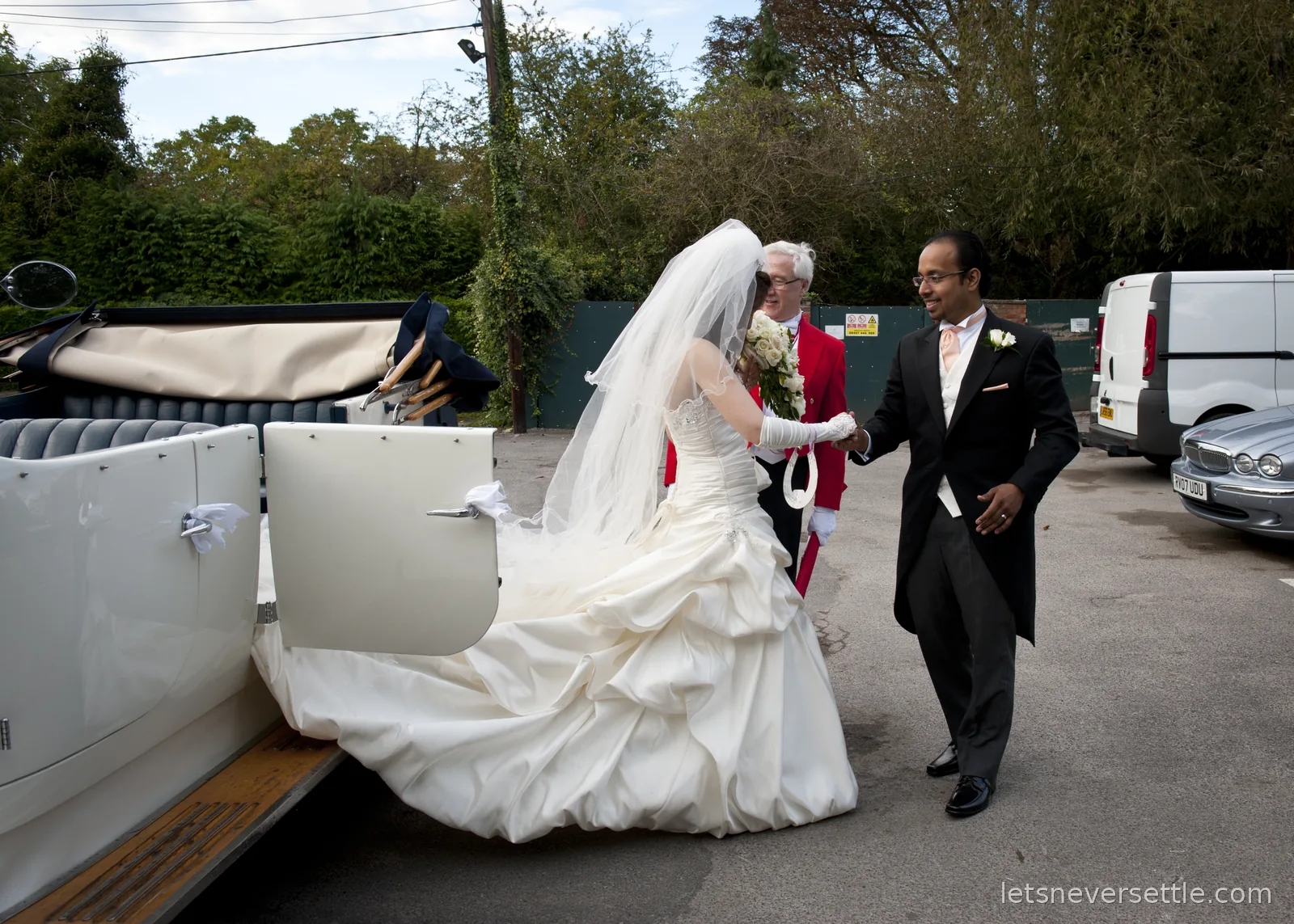 Dileep handing Inga down from the vintage Rolls-Royce at the reception, a toastmaster in a red tailcoat standing by