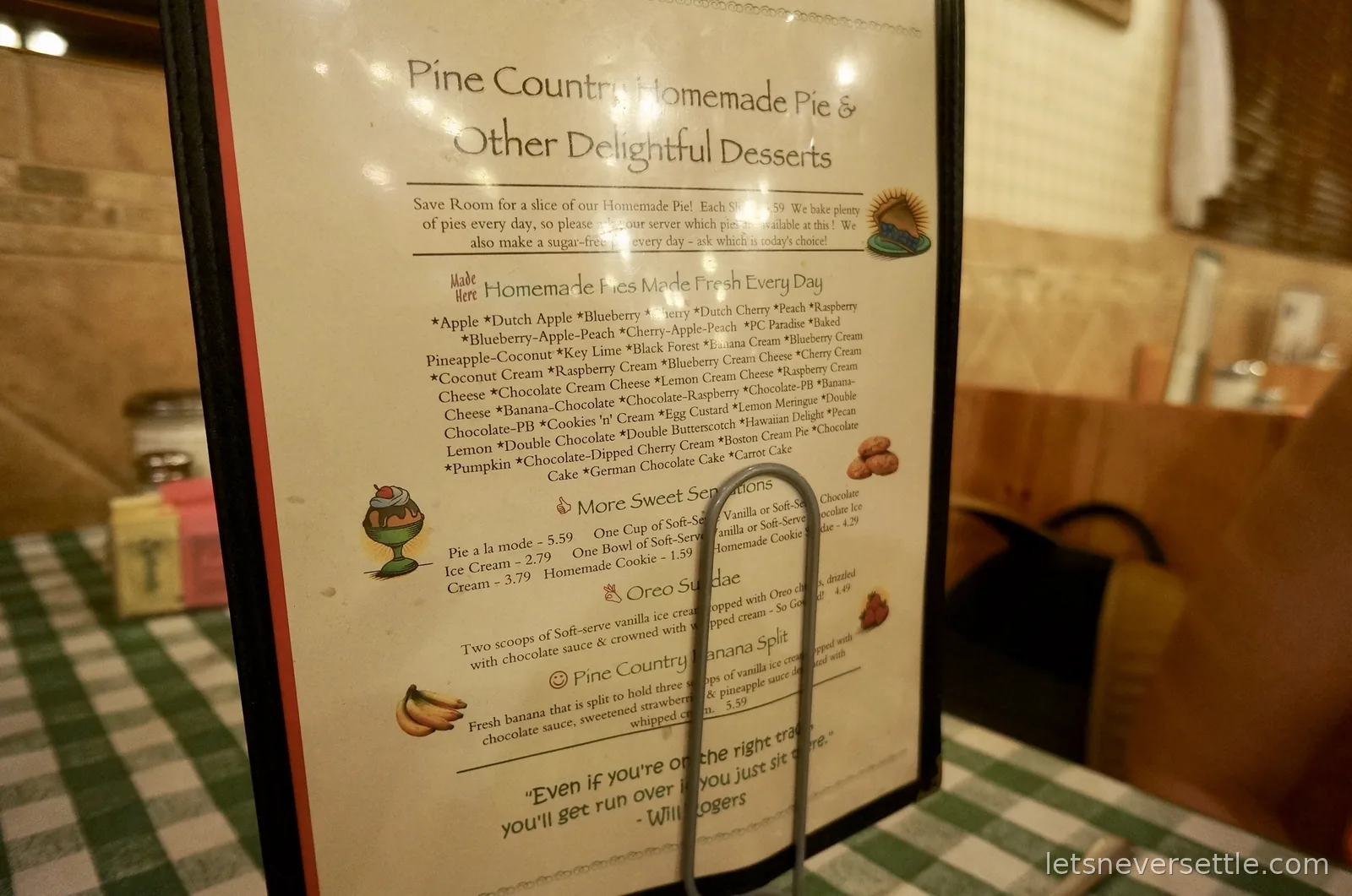 Pine Country Restaurant dessert menu listing dozens of homemade pies, propped on a green checked tablecloth