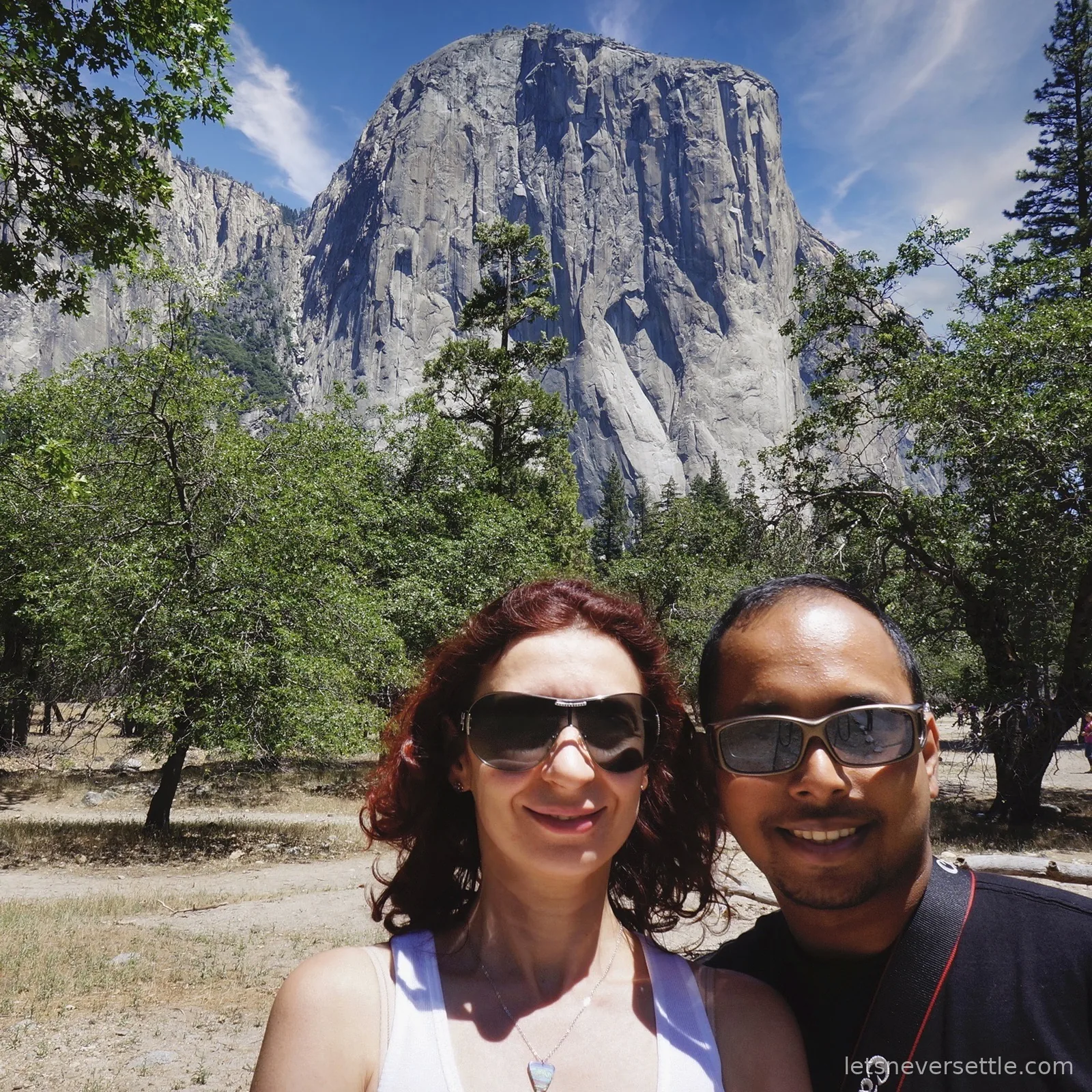 Selfie of Inga and Dileep smiling in front of the sheer granite face of El Capitan