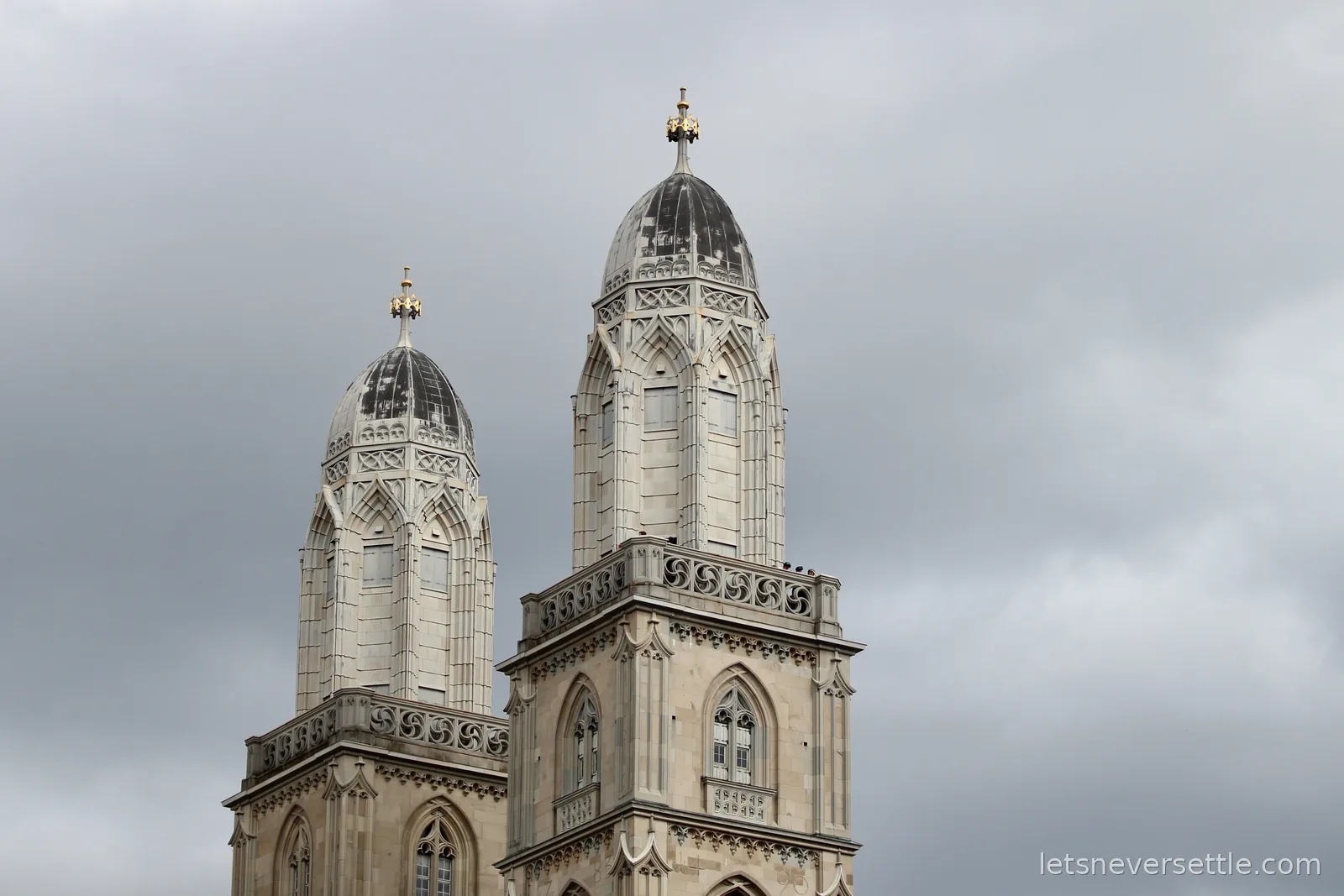 The twin domed towers of the Grossmunster in Zurich against a grey sky